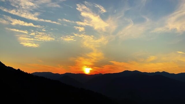 Dramatic sunrise time-lapse featuring a thick sea of clouds moving rapidly over the peaks of Ailao Mountain in Yunnan.