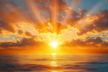 Obraz premium Golden sunburst over calm ocean with dramatic clouds and shimmering reflection, evoking tranquility and awe