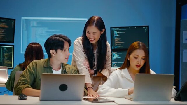 Asian software engineer or programmer team working late in development office,problem solving or algorithm of ai assistant helping for work.software developer,digital technology security concept