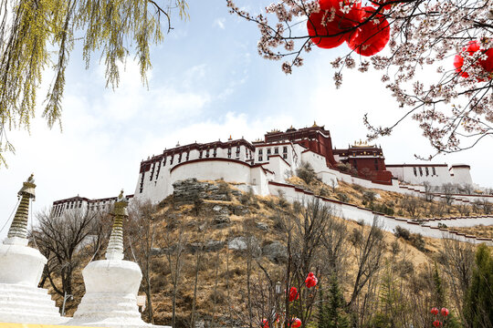 Potala Palace in Lhasa Tibet with spring blossoms and red lanterns