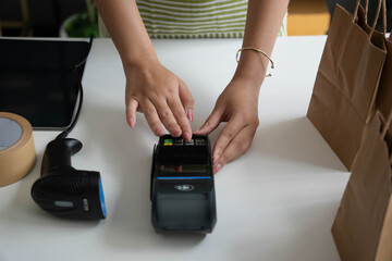 Fototapeta premium Asian woman using payment device for online shop