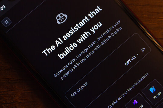 Mexico City, MEXICO - Apr 14 2026 : A smartphone on a wooden surface displays the GitHub Copilot interface.