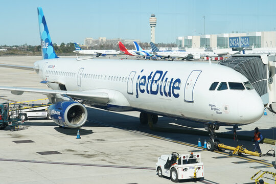 A JetBlue airplane waits to board passengers at Orlando International Airport in Orlando, Florida on January 19, 2026.