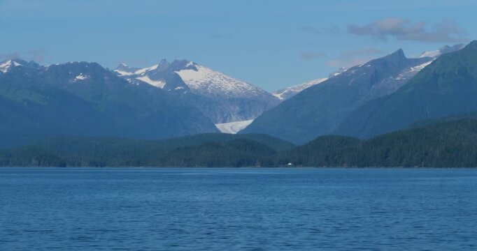 Sailing out from Juneau, Alaska, in a sunny day.Mendenhall Glacier and the surrounding mountains in the background.