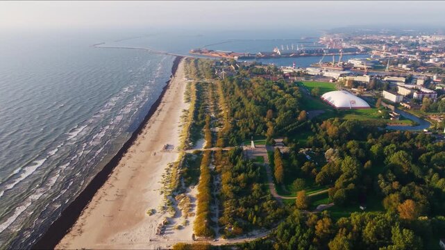 Evening aerial shows Baltic coast waves beach and port Liepaja Latvia