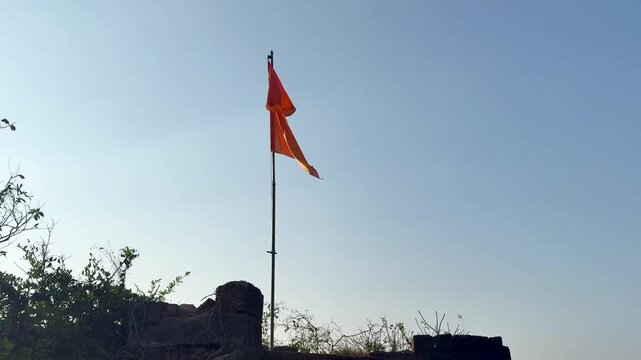 Beautiful 4K view of Jaigad Fort with the saffron flag flying proudly above ancient walls. Coastal winds, historic strength, open skies, and majestic Konkan scenery create a powerful scene.