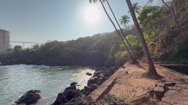 Beautiful wide-angle 4K view of Karhateshwar Mandir overlooking the Arabian Sea, with the distant JSW plant, rocky coast, open skies, and stunning Konkan landscape blending nature and industry.
