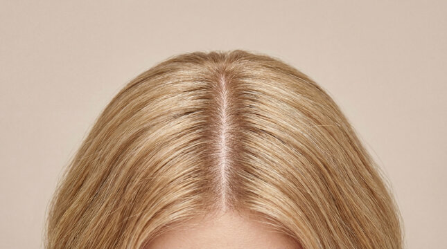 Top view detailed hair scalp parting blonde healthy woman closeup roots natural beauty care clean straight smooth shine texture head skin female