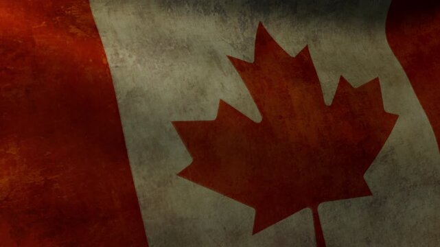 Close-up of the flag of Canada with weathered fabric waving in the wind