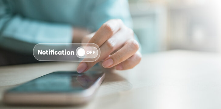 User turning off notifications on smartphone with digital interface, representing focus mode, do not disturb settings, and personal control over alerts in modern mobile lifestyle.