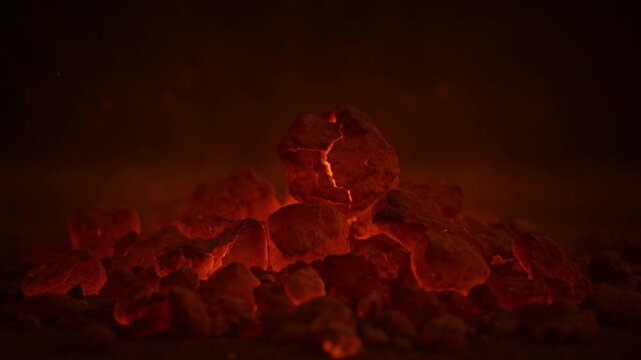 Glowing Embers: A mesmerizing close-up of smoldering embers, radiating a warm, inviting glow against a dark backdrop. Capturing the raw power and subtle beauty of a controlled fire.
