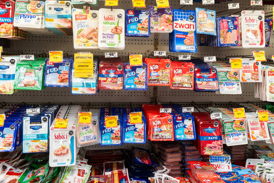 Villa de Alvarez, Colima. Mexico. March 6, 2026: Vibrant Colorful Wide Angle Full Shelf Display of Packaged Sliced Deli Meat Products in a Supermarket Aisle