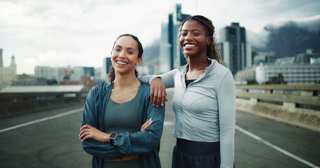 Naklejka premium Happy, portrait and women in city for fitness, cardio workout or support on bridge. Female people, overcast or runners training for wellness, sports and exercise outdoor on urban street together