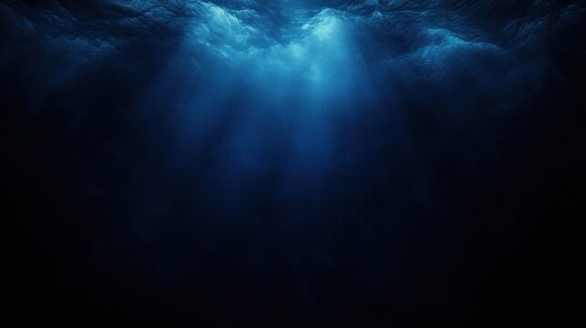 deep blue ocean with shafts of sunlight piercing dark water, evoking a serene, mysterious and immersive underwater atmosphere