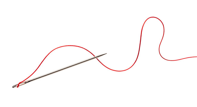 Close up of a sewing needle threaded with red yarn