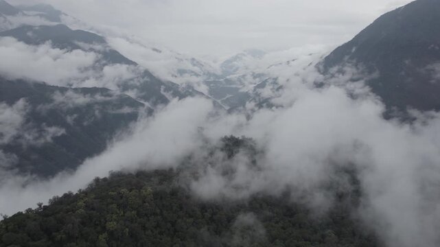 "Cinematic aerial drone footage of the dramatic mountain landscape surrounding Buqun Lake, overlooking the distant Yarlung Tsangpo River valley in Medog, Tibet. Captured in DJI D-Log flat profile, per