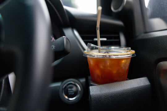 Cold beverage in car, suggesting pause during a drive