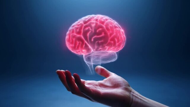A vibrant red glowing human brain digitally rendered, hovering above an open hand in a dark blue futuristic setting.