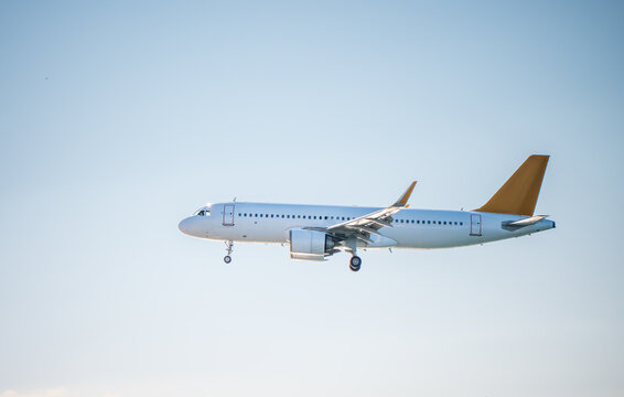 Passenger airplane landing against clear blue sky, commercial aviation transport concept for travel, tourism, airport logistics, mobility, global transportation.