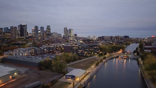 Aerial night skyline of Montreal with Lachine Canal, illuminated bridge, downtown skyscrapers and city lights in Quebec, Canada. g.