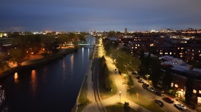 Aerial night skyline of Montreal with Lachine Canal, illuminated bridge, downtown skyscrapers and city lights in Quebec, Canada. g.