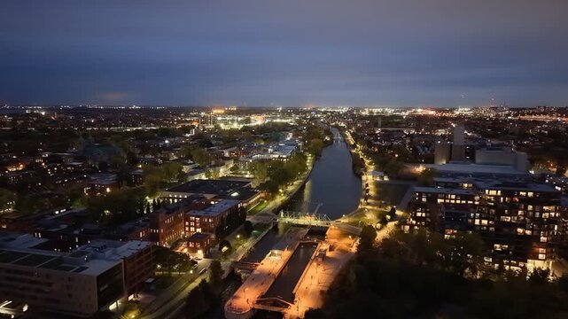 Aerial night skyline of Montreal with Lachine Canal, illuminated bridge, downtown skyscrapers and city lights in Quebec, Canada. g.