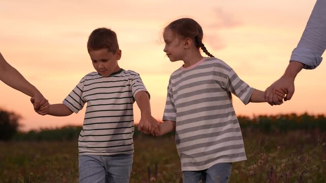 mother father children boy girl park sunset, man woman toddlers outdoors, Sure Here are 10 options for image titles in English, separated by commas:
