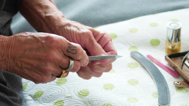 older lady woman hands during a manicure session. Highlighting skin texture and the process of nail maintenance as part of a healthy aging and wellness routine