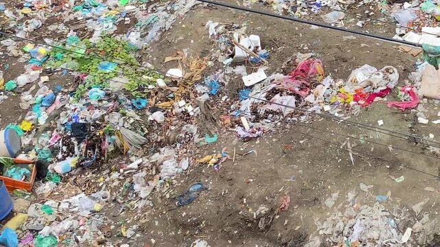 Environmental pollution: Plastic waste and city garbage polluted soil.
