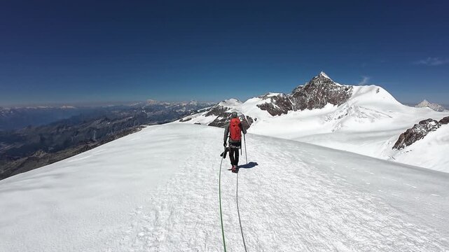 POV mountaineering in rope team with mountaineer and mountain glacier panorama with summit Lyskamm in summer in Pennine Alps, Italy