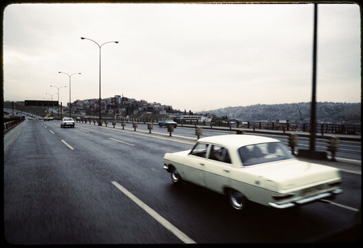 Vintage Cars Driving on Urban Highway Scene