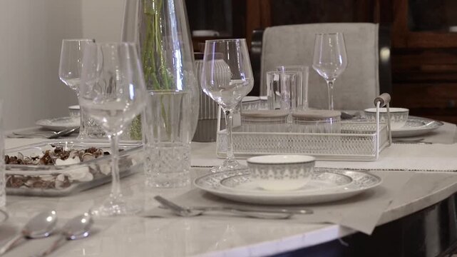Cinematic video of a dining table with wine glass and other cutlery 