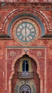 Aerial view of the ornate Moorish facade and clock tower of Castello di Sammezzano with intricate brickwork and architectural details in Reggello, Tuscany, Italy.