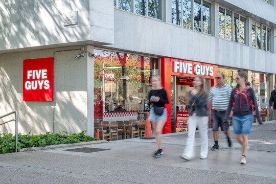 Five Guys Restaurant Entrance with People in Barcelona, Spain, Burgers and Fries