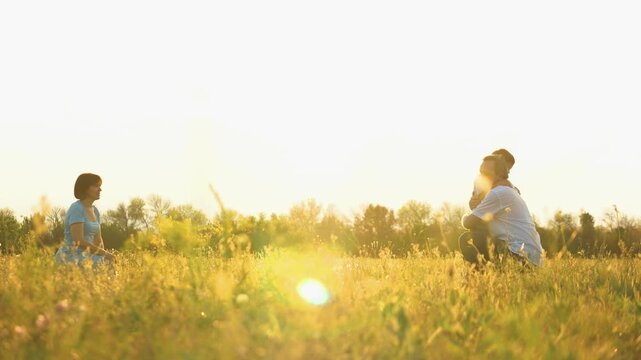 family outdoors, happy family, child kid with parents playing on a walk, father catches running child, father catches child in arms, kid child weekend relaxation, summer day walk in nature, mother