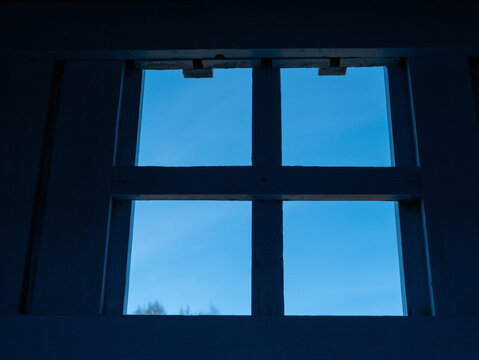 window with four squares against blue sky