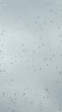 The weather is bad. Raindrops glisten on the windowpane against the backdrop of a gloomy, cold sky. It doesn&rsquo;t feel cozy - Vertical video