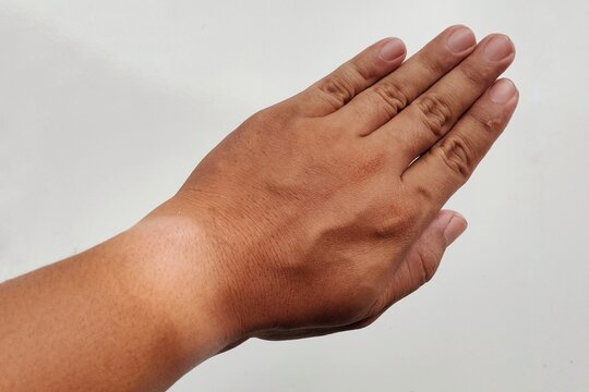 Close-up human wrist with tan line from watch or bracelet