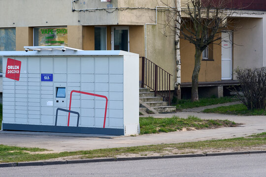 Orlen Paczka automated parcel locker station located on a sidewalk near a residential building, Gdansk, Pomeranian Voivodeship, Poland, Europe