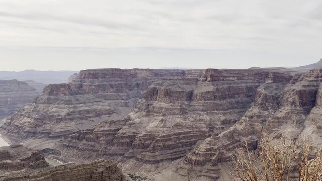 Scenic panoramic view of the Grand Canyon West Rim in Arizona, USA. Desert landscape with layered red rock cliffs, deep canyon formations, Colorado River view. A road trip near Eagle and Guano Point.