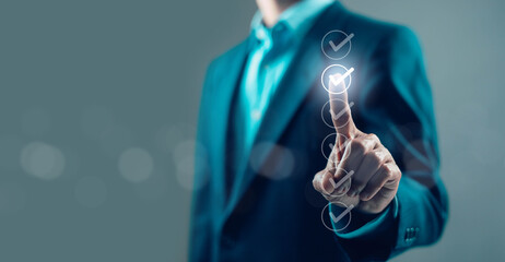Businessman pressing digital checklist with glowing check marks, quality assurance, task completion, workflow management, compliance audit, productivity and modern business technology concept © wanchai peatoo
