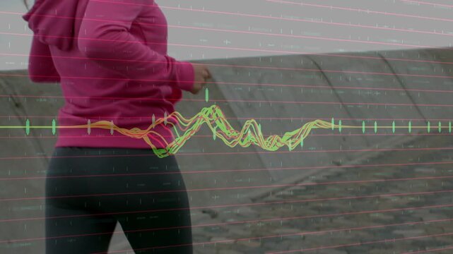 Woman jogging along coastal seawall for fitness, camera panning up, waveform overlaying center