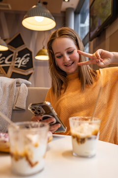 teen friends eating vegetarian burgers in cafe