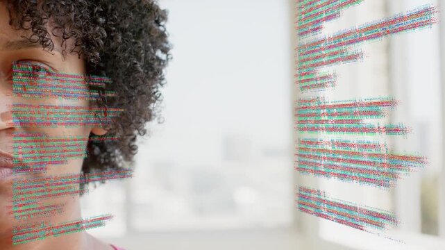 Vertical video: Mid-adult woman smiling with code overlays appearing over face, showing tech demo
