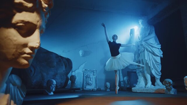Young talented woman dancing in darkness, ballerina in museum, female silhouette . Attractive slender female dancer performing classical choreography, unusual rehearsal hall in old museum, ghost dance