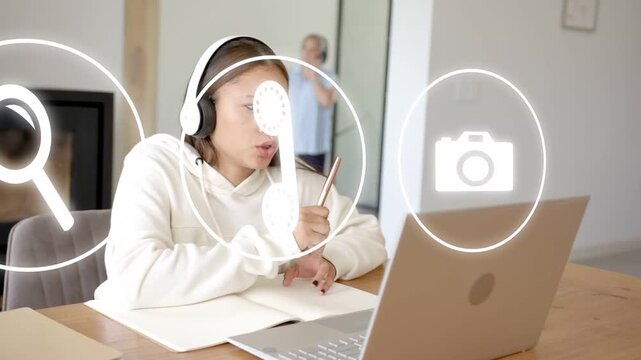 Teenager presenting to laptop, pointing and tapping as animated UI icons appearing for online class