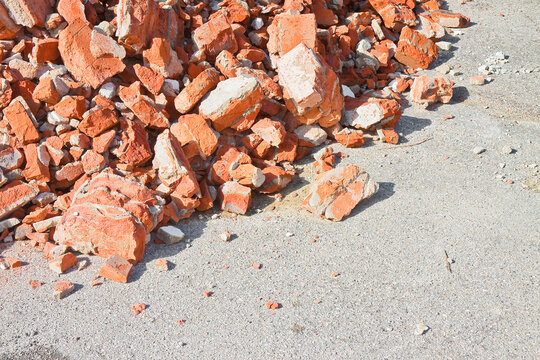 Concrete and brick rubble debris on construction site after a demolition of a brick building