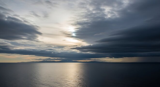 Dramatic skyscape with dark clouds reflecting on a calm ocean surface