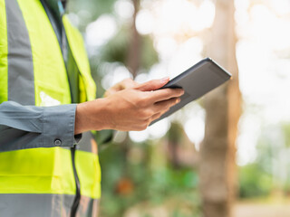 Asian engineer using tablet for digital monitoring and project management in engineering work. © Charlie's