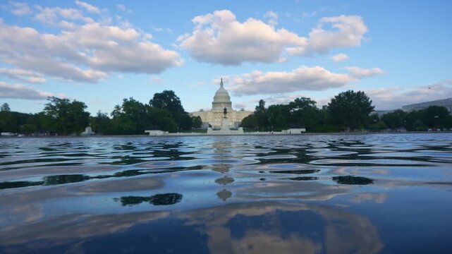 Washington DC politics and democracy concept. US Capitol monument in daylight. Washington DC federal government symbol. Capitol building with clouds. Washington DC iconic landmark.